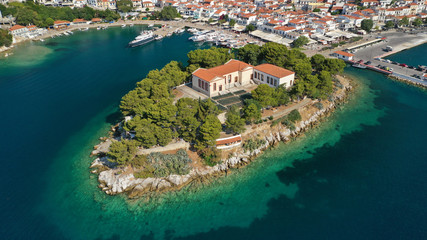 Aerial drone photo of amazing vegetated islet of Bourtzi built in small peninsula in port of Skiathos island main town hosting an old school, Sporades, Greece