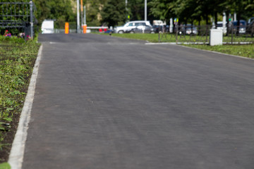 Fototapeta na wymiar New asphalt on the sidewalk, renovation completed