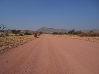 Fototapeta na wymiar red road in desert in Africa