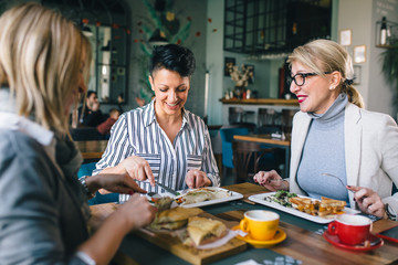 woman having lunch outdoor in restaurant