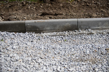 Road works in the old town. Stones and pavement tiles on the ground. Reconstruction on the streets. Sidewalk repair. Concrete.