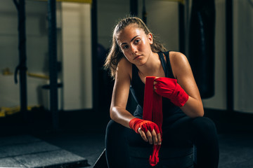 woman kickboxing puts bandages on her hands