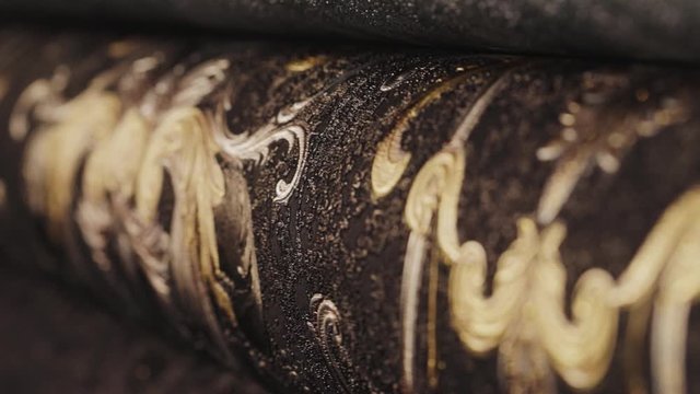 Rolls with wallpaper. Ornament close-up. Stand with wallpaper in the store