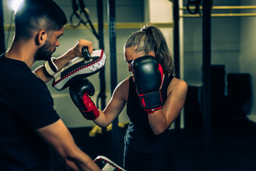 woman training kick box with his personal trainer