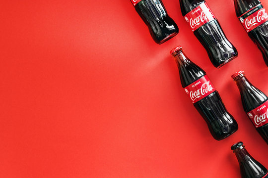 Moscow, Russia-July 9, 2020: Coca Cola in bottles on a red background. Coca-Cola is a carbonated non-alcoholic beverage sold all over the world