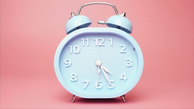 Alarm clock Four o'clock isolated on pink background.