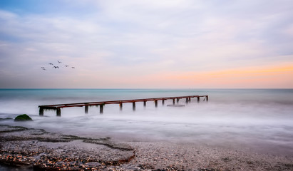 Old Worn Pier Columns,  Logs of remains of the old, wooden pier, in the sea