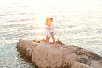 Very romantic moments. Young couple, sunset and sea.