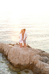 Very romantic moments. Young couple, sunset and sea.