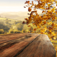 Wooden table of free space and blurred landscape of autumn 