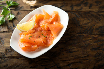 Homemade smoked salmon with fresh lemon