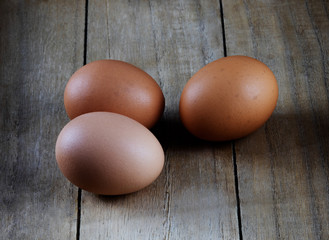 three eggs on wooden board