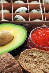 Healthy food set. Keto set. Top view. Avocado, bread, quail eggs, red caviar. The keto diet.