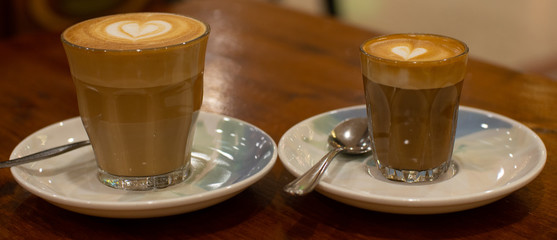 Glass of Coffee Piccolo Latte on a wooden table