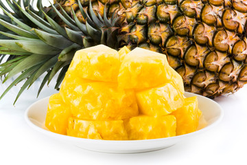 Sliced pineapple on a white plate, it is a sweet and juicy fruit.
