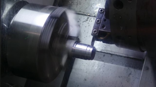 the CNC machine grinds the metal part, video