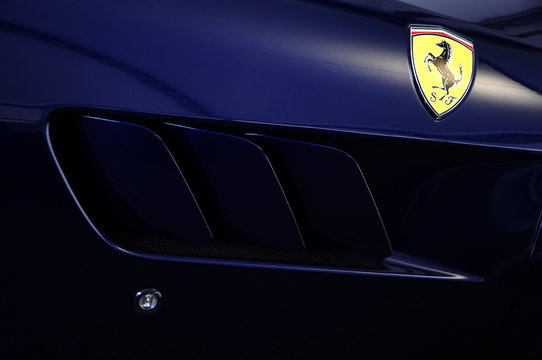 Detail of Ferrari Logo on Sport Car in the Paddock of Mugello Circuit. Ferrari S.P.A. is an Italian luxury sports car manufacturer, founded by Enzo Ferrari.