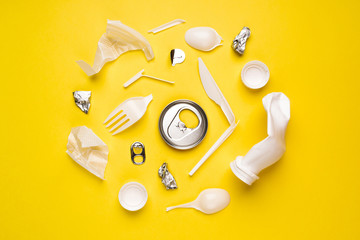 Different kinds of plastic garbage. Food plastic packaging on yellow background.