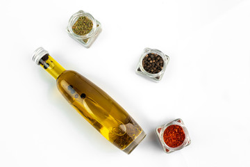 Fototapeta na wymiar glass bottle of extra virgin oil with thyme, garlic and pepper