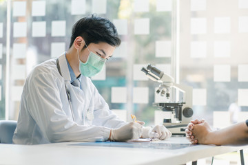 Doctor and patient at medical examination in hospital office. Medicine and healthcare concept.