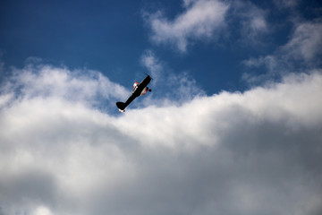 Air Force Monoplane Climbing into a Cloudy Sky at a Public Air Show