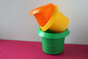  green, orange and yellow plastic sandbox cups