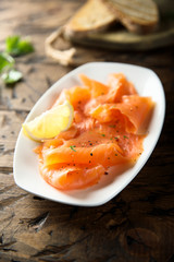 Homemade smoked salmon with lemon