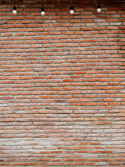 old brick wall with hanging light bulb