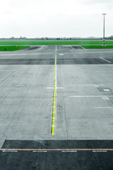 Myst on empty airport runway tarmac with directional and markings sign