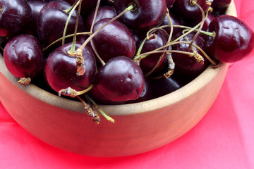 red cherries on a colorful fabric background