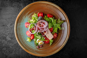 Gourmet hot salad made with boiled turkey breast, beans, quail eggs and sun dried tomatoes with herbs . Balanced dietary nutritious food.