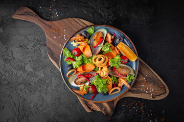 Gourmet hot salad made with seafood with citrus and fresh herbs. Balanced dietary nutritious food.
