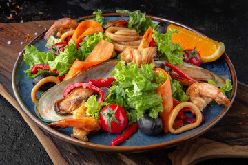 Gourmet hot salad made with seafood with citrus and fresh herbs. Balanced dietary nutritious food.