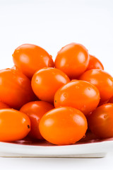 Close-up of fresh cherry tomatoes on a white dish