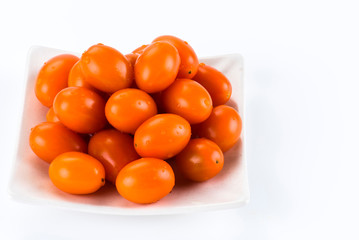 Close-up of fresh cherry tomatoes on a white dish
