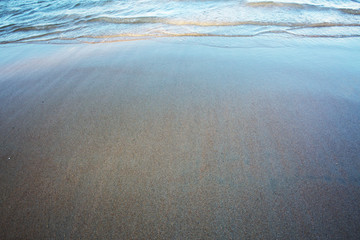 Wave of the sea on the sand beach. Travel background.