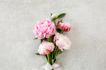 Bouquet of a lot of peonies of pink color close up. Flat lay, top view. Peony flower texture.