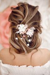 Closeup of Bridal wedding hairstyle with jewelry wreath. Back view. Elegant bride with Wavy hair.