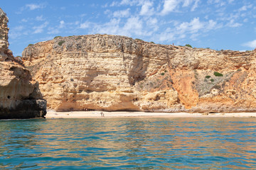 Fototapeta na wymiar View from the sea of Carvoeiro beach. The Lagoa region has a coastline formed of towering cliffs, turquoise waters and picturesque beaches. The beaches of Carvoeiro are found within sheltered coves