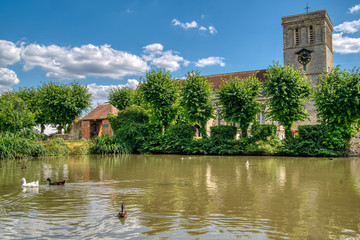 Fototapeta na wymiar Village pond and church