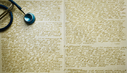 Hand-written medical text. Stethoscope over hand-written medical notes. Medical writing or...