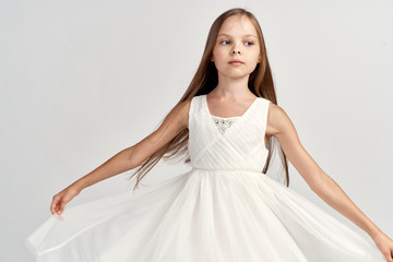 Fototapeta na wymiar girl ballerina in white costume pointe shoes tutu dance light background cropped view