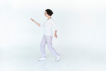 woman practicing qi qong at white studio traditional chinese gymnastics	