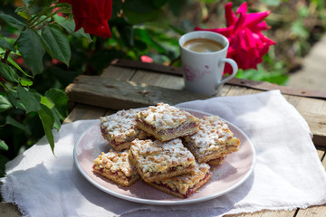 Streusel pie stuffed with rose jam, served with coffee. Rustic style.