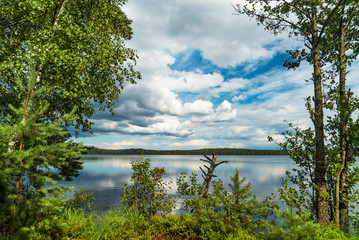 Fototapeta na wymiar Blue sky with white clouds over the lake on a Sunny summer day.