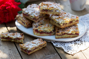 Streusel pie stuffed with rose jam, served with coffee. Rustic style.
