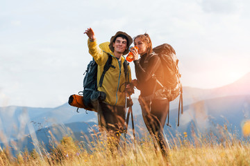 Beautiful young people travel together. Majestic Carpathian Mountains. Beautiful landscape of untouched nature © standret