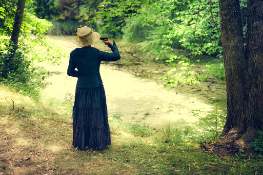 Woman with pistol in hand.