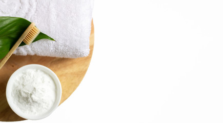 Wooden natural eco-friendly toothbrush, baking soda. A clean fresh white towel. On a wooden stand and a white background. Dental care and the concept of zero waste. Copy space/