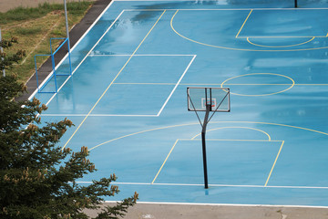 basketball court wet from the rain in a residential area © Anna